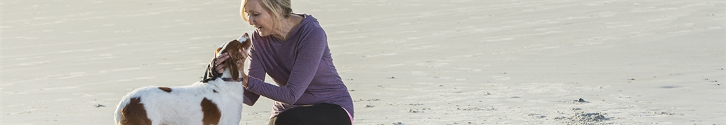 woman and dog on beach
